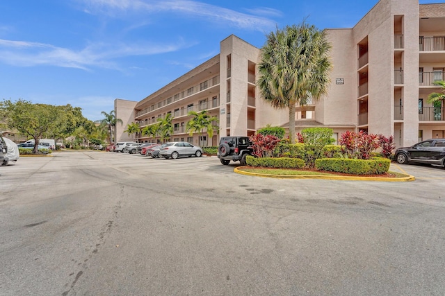 view of building exterior featuring uncovered parking