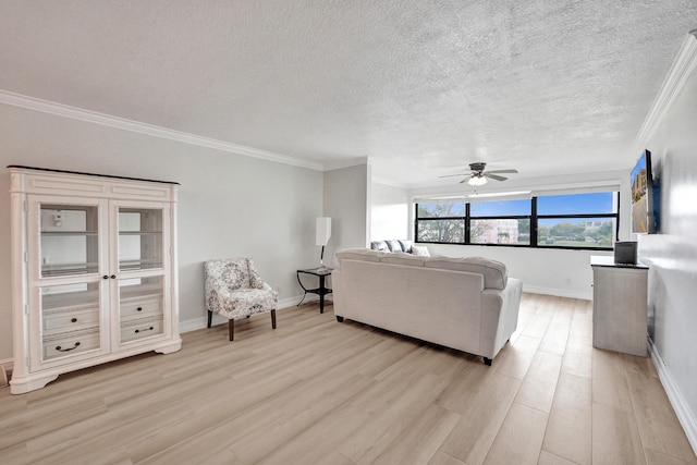 living room with a ceiling fan, light wood-style flooring, a textured ceiling, and ornamental molding