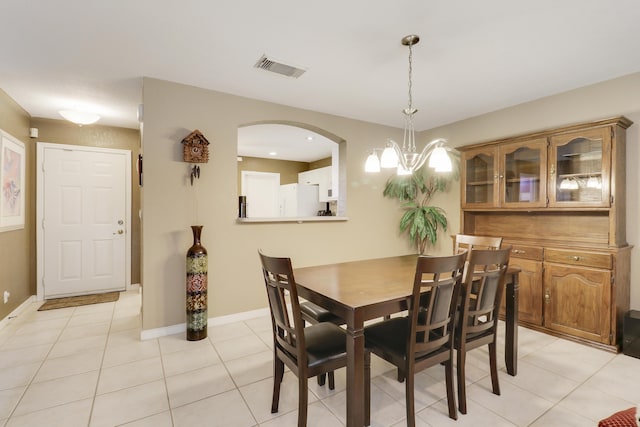 6170 Sugar Loaf Ln, West Palm Beach, FL 33411 - dining room with arched walkways, an inviting chandelier, light tile patterned floors, baseboards, and visible vents