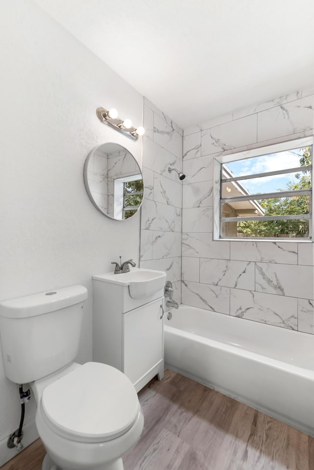 1134 NW 18th Ave, Fort Lauderdale, FL 33311 - bathroom featuring toilet, wood finished floors, vanity, and shower / bath combination