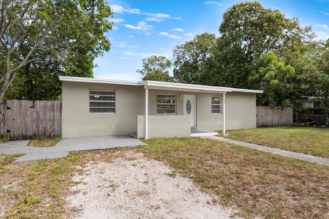 1134 NW 18th Ave, Fort Lauderdale, FL 33311 - ranch-style house featuring a front yard, stucco siding, and fence
