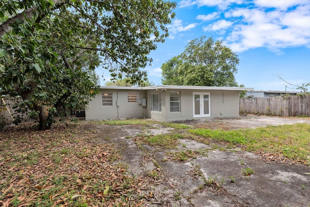 1134 NW 18th Ave, Fort Lauderdale, FL 33311 - view of front of property with stucco siding, fence, french doors, and a patio area
