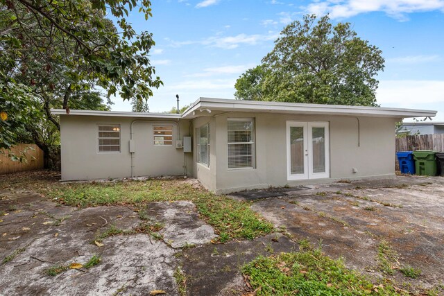 1134 NW 18th Ave, Fort Lauderdale, FL 33311 - back of house featuring stucco siding, fence, and french doors