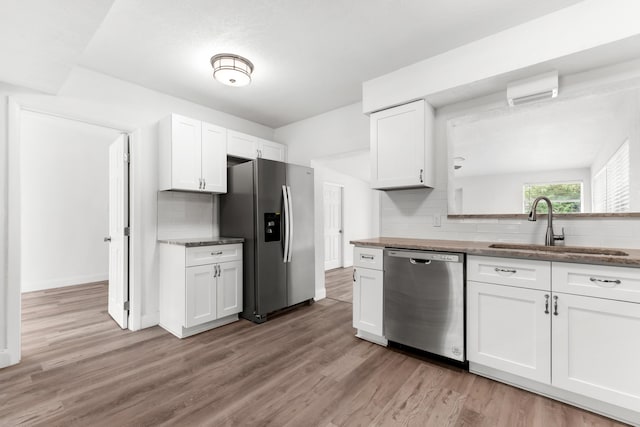 1134 NW 18th Ave, Fort Lauderdale, FL 33311 - kitchen with light wood-style floors, a sink, stainless steel appliances, and backsplash