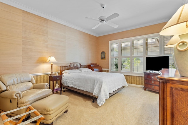 bedroom featuring light carpet, baseboards, wallpapered walls, a ceiling fan, and ornamental molding