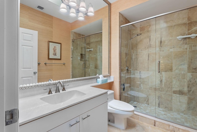bathroom featuring vanity, visible vents, a shower stall, and toilet
