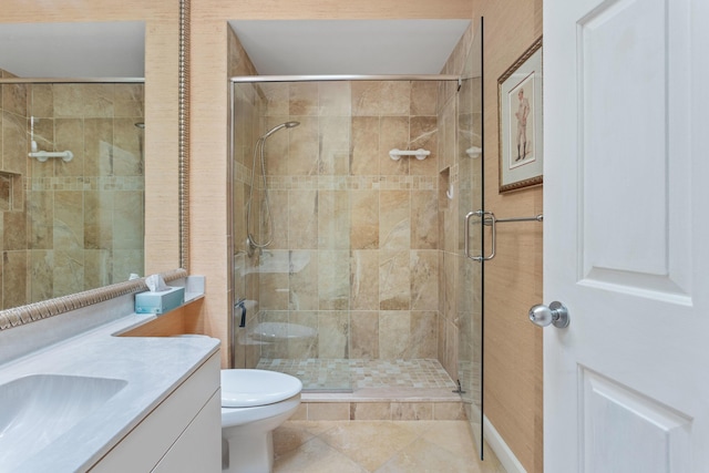 bathroom with a shower stall, toilet, and vanity