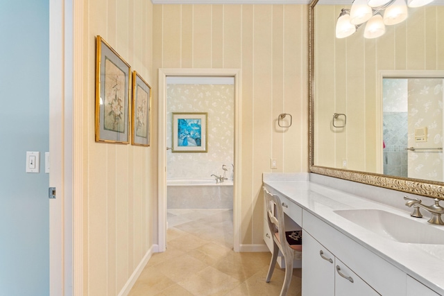 full bathroom with tile patterned floors, baseboards, wallpapered walls, a garden tub, and vanity