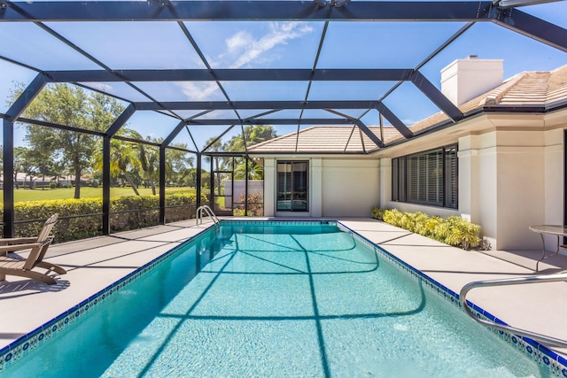 outdoor pool featuring a lanai and a patio area