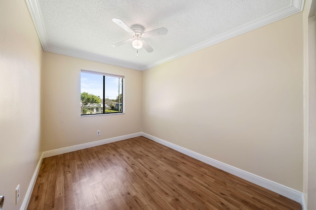spare room featuring baseboards, wood finished floors, ceiling fan, and a textured ceiling