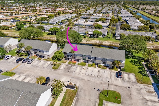 birds eye view of property featuring a residential view and a water view