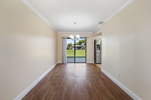 unfurnished dining area with visible vents, a chandelier, baseboards, ornamental molding, and dark wood finished floors