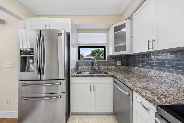kitchen with a sink, ornamental molding, appliances with stainless steel finishes, and decorative backsplash