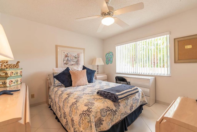 bedroom with a textured ceiling, baseboards, and light tile patterned floors