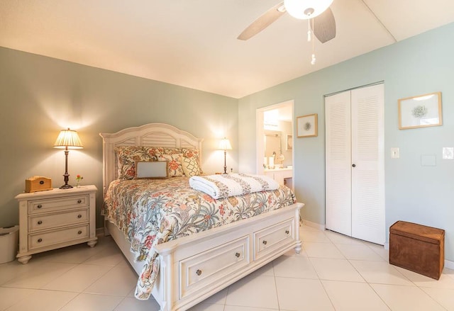 bedroom with a ceiling fan, light tile patterned floors, connected bathroom, and a closet