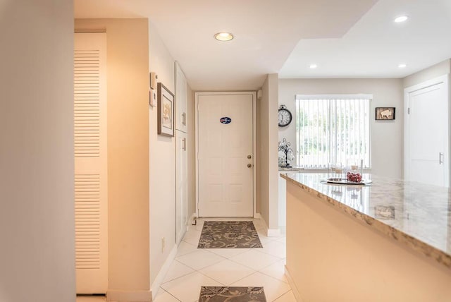 interior space with light tile patterned floors, baseboards, and recessed lighting