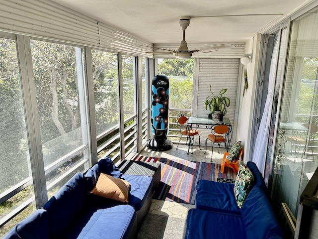 sunroom featuring a ceiling fan