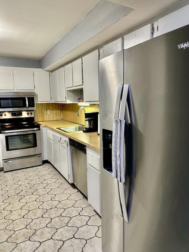 kitchen featuring a sink, light countertops, white cabinetry, and stainless steel appliances