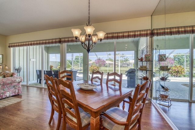 2036 SW Mayflower Dr, Palm City, FL 34990 - dining area with wood finished floors and a chandelier