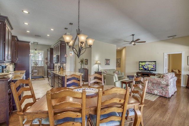 2036 SW Mayflower Dr, Palm City, FL 34990 - dining area with a ceiling fan, recessed lighting, a chandelier, light wood-type flooring, and lofted ceiling