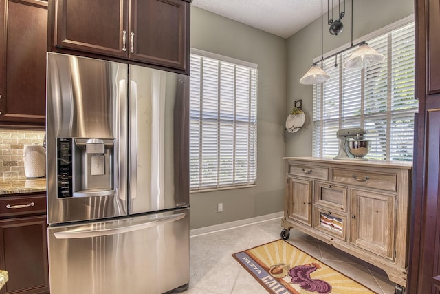 2036 SW Mayflower Dr, Palm City, FL 34990 - kitchen featuring stainless steel fridge with ice dispenser, healthy amount of natural light, tasteful backsplash, and dark brown cabinets