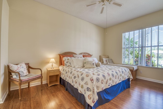 2036 SW Mayflower Dr, Palm City, FL 34990 - bedroom with wood finished floors, baseboards, and ceiling fan