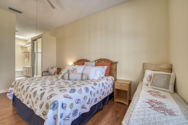 2036 SW Mayflower Dr, Palm City, FL 34990 - bedroom featuring wood finished floors, ensuite bath, and ceiling fan