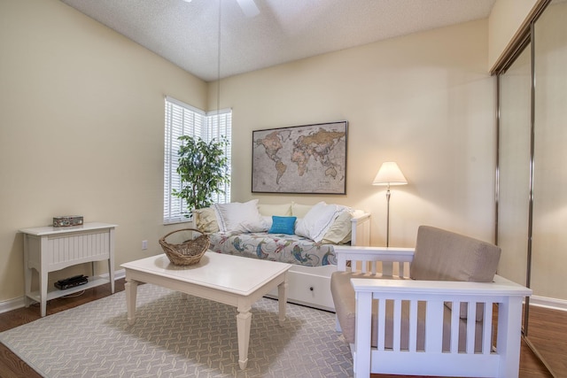 2036 SW Mayflower Dr, Palm City, FL 34990 - living area with a ceiling fan, wood finished floors, baseboards, and a textured ceiling