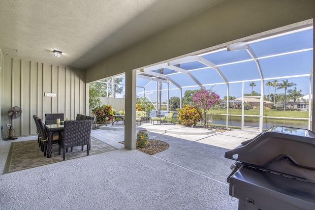 2036 SW Mayflower Dr, Palm City, FL 34990 - view of patio / terrace featuring outdoor dining area, a water view, a grill, and glass enclosure