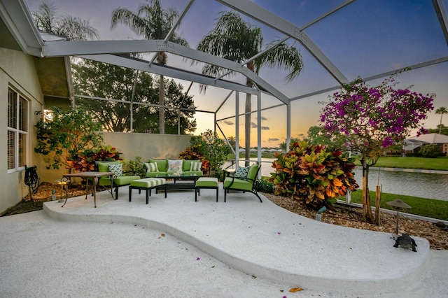 2036 SW Mayflower Dr, Palm City, FL 34990 - patio terrace at dusk featuring outdoor lounge area, a water view, and a lanai