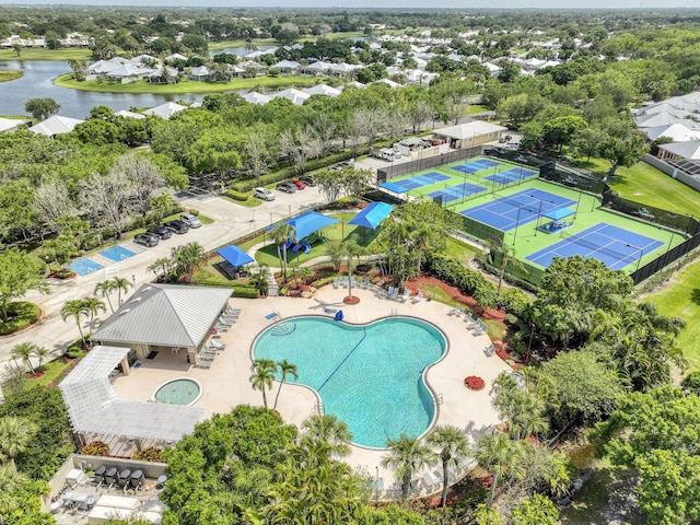 2036 SW Mayflower Dr, Palm City, FL 34990 - drone / aerial view of a pool, a nearby body of water, and a tree filled landscape