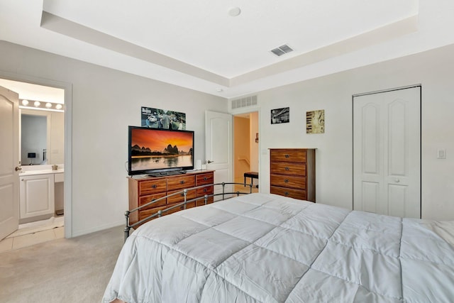 2061 SE Glen Ridge Dr, Port Saint Lucie, FL 34952 - bedroom featuring light carpet, baseboards, visible vents, and a tray ceiling