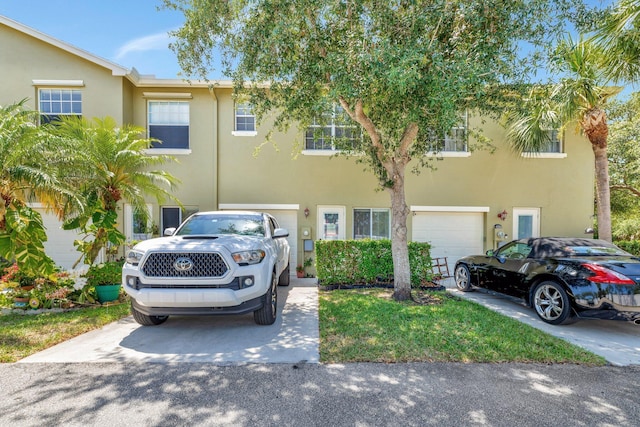 2061 SE Glen Ridge Dr, Port Saint Lucie, FL 34952 - townhome / multi-family property with concrete driveway, stucco siding, and a garage