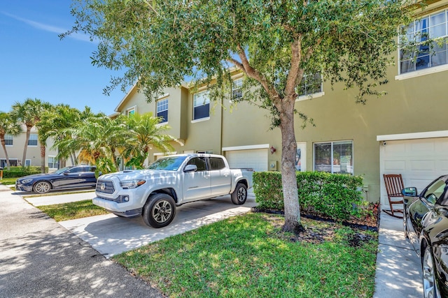 2061 SE Glen Ridge Dr, Port Saint Lucie, FL 34952 - multi unit property with a garage, driveway, and stucco siding