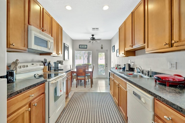 2061 SE Glen Ridge Dr, Port Saint Lucie, FL 34952 - kitchen featuring recessed lighting, dark countertops, a ceiling fan, a sink, and white appliances