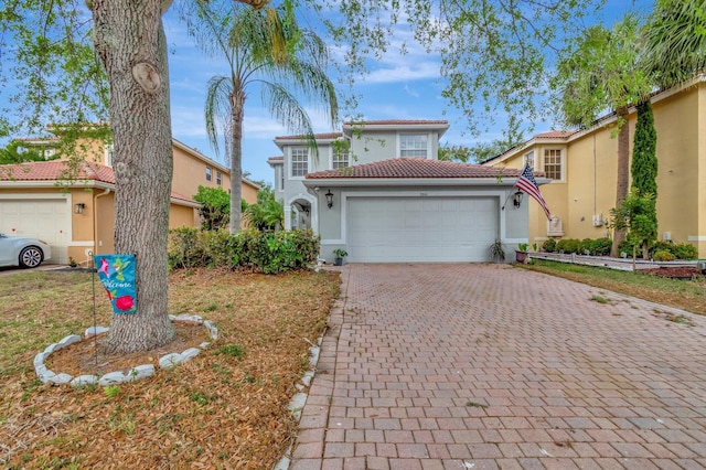 5541 Wishing Star Ln, Greenacres, FL 33463 - mediterranean / spanish-style home featuring stucco siding, a tile roof, a garage, and decorative driveway