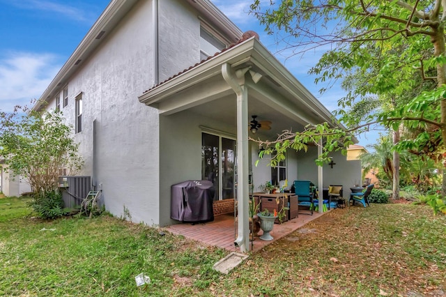 5541 Wishing Star Ln, Greenacres, FL 33463 - back of property featuring cooling unit, stucco siding, a patio, ceiling fan, and a yard