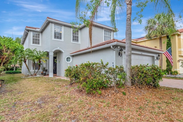 5541 Wishing Star Ln, Greenacres, FL 33463 - mediterranean / spanish-style home featuring decorative driveway, stucco siding, an attached garage, and a tiled roof