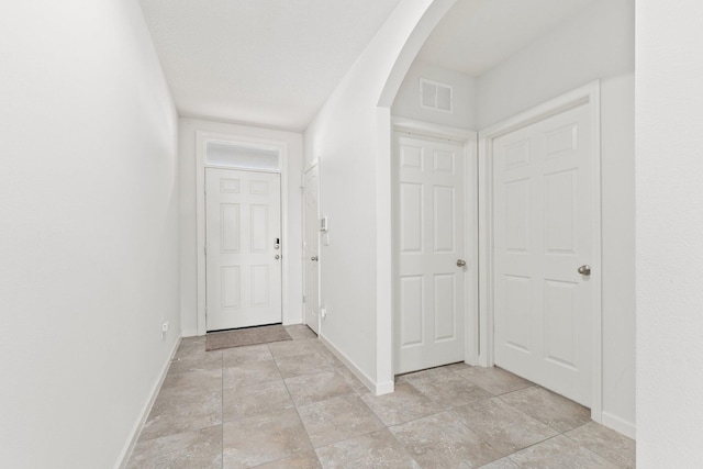 9213 Potomac Dr, Fort Pierce, FL 34945 - hall with baseboards, visible vents, and arched walkways
