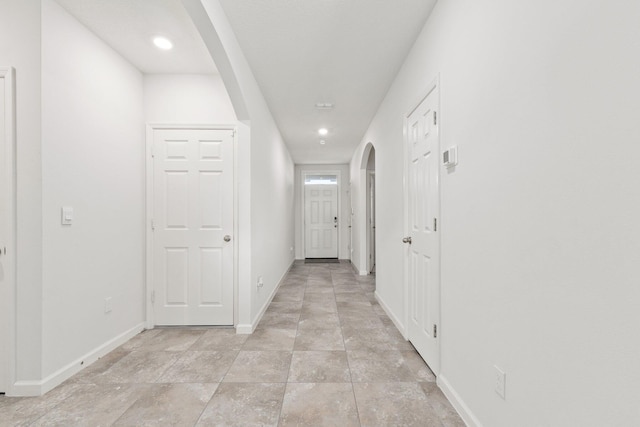 9213 Potomac Dr, Fort Pierce, FL 34945 - corridor with baseboards, arched walkways, and recessed lighting