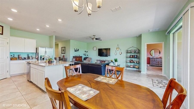 10577 SW Toren Way, Port Saint Lucie, FL 34987 - dining room with light tile patterned flooring, recessed lighting, ceiling fan, and a chandelier