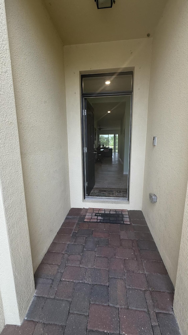 entrance to property with stucco siding