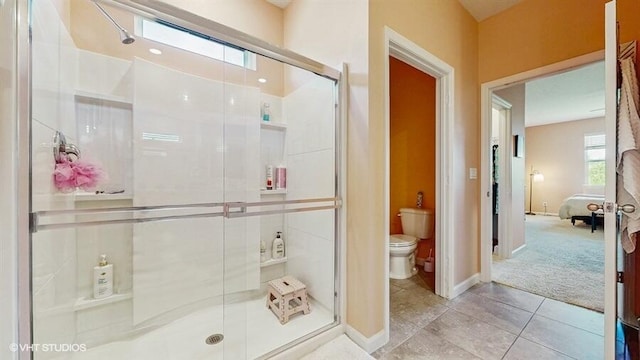 10577 SW Toren Way, Port Saint Lucie, FL 34987 - ensuite bathroom featuring toilet, a shower stall, tile patterned floors, and baseboards