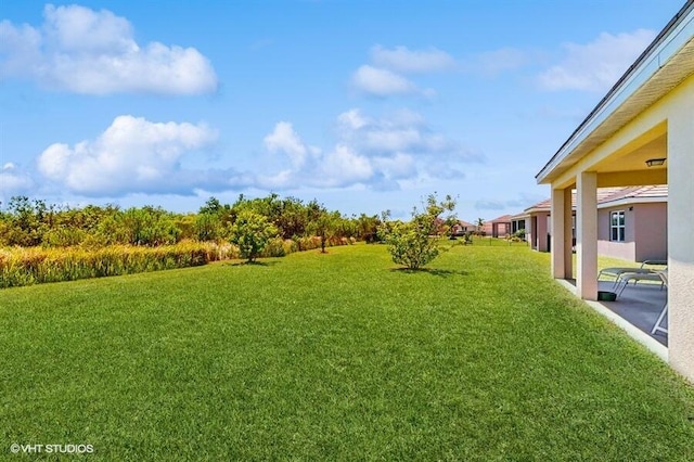 10577 SW Toren Way, Port Saint Lucie, FL 34987 - view of green lawn featuring a patio