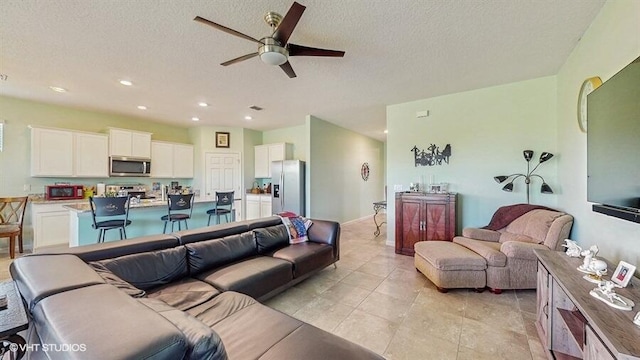 10577 SW Toren Way, Port Saint Lucie, FL 34987 - living area with a ceiling fan, a textured ceiling, recessed lighting, and light tile patterned floors
