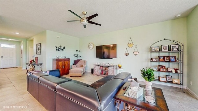 10577 SW Toren Way, Port Saint Lucie, FL 34987 - living room with light tile patterned floors, a ceiling fan, a textured ceiling, baseboards, and recessed lighting