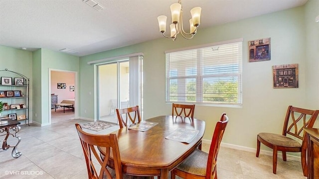 10577 SW Toren Way, Port Saint Lucie, FL 34987 - dining space with light tile patterned floors, a chandelier, and baseboards
