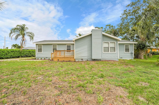 1701 SE Floresta Dr, Port Saint Lucie, FL 34983 - rear view of property with crawl space, a wooden deck, a yard, and a chimney