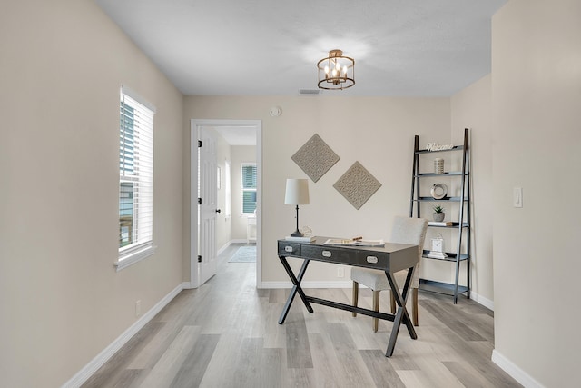 1701 SE Floresta Dr, Port Saint Lucie, FL 34983 - office space featuring light wood-type flooring, a chandelier, and baseboards