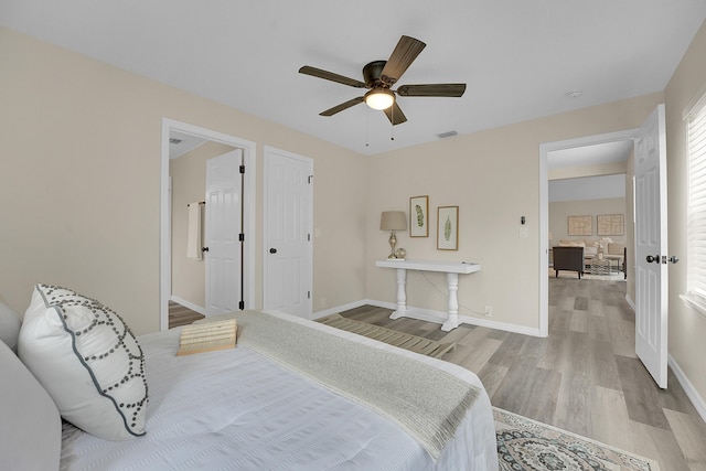 1701 SE Floresta Dr, Port Saint Lucie, FL 34983 - bedroom with wood finished floors, baseboards, and ceiling fan